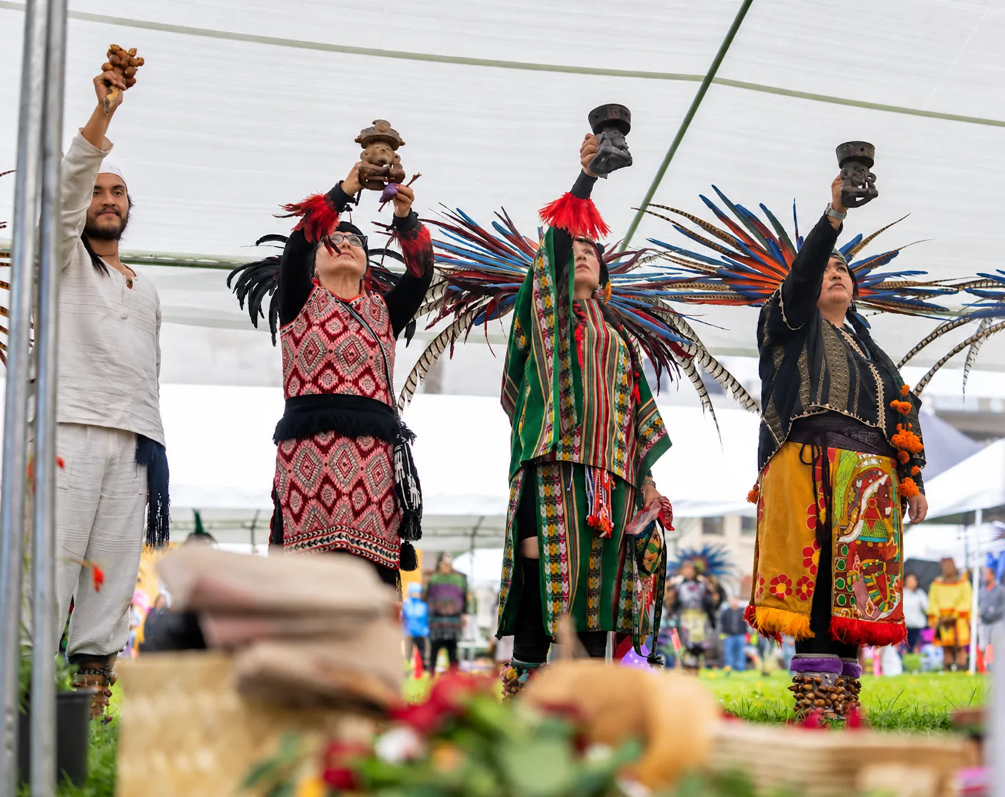 Sahumadoras raise ceremonial vessels skyward during the Día de Muertos ceremony